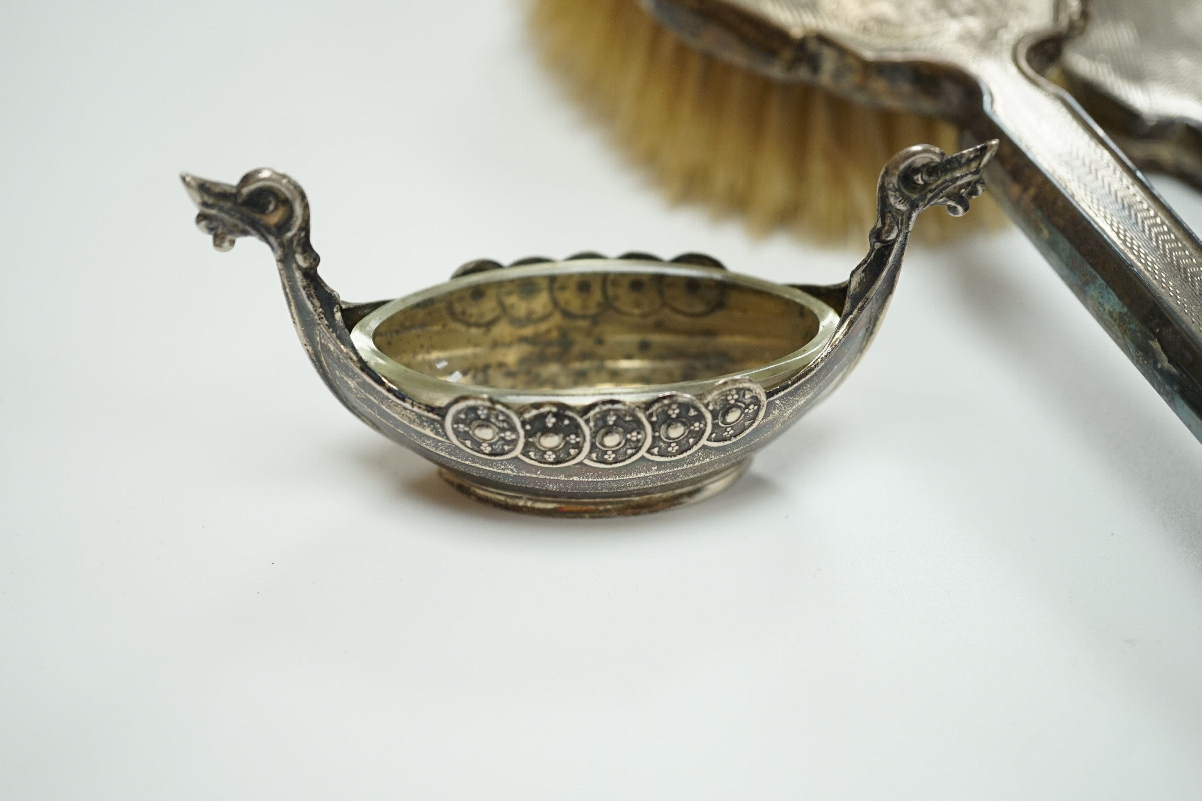 A George V silver mounted trinket box, Elkington & Co, Birmingham, 1918, 13.1cm, a silver mustard pot, two Scandinavian 925 condiments, two silver mounted scent bottles, hatpins and hatpin stand and a silver mounted thre